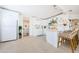 Kitchen featuring white cabinetry, island with seating, and stainless appliances at 2261 Queen S St, St Petersburg, FL 33712