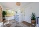 Bright laundry room with white brick, neutral floors, bamboo blind, and plants at 2261 Queen S St, St Petersburg, FL 33712