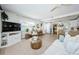 Bright living room featuring white couch, woven coffee table, and view into kitchen at 2261 Queen S St, St Petersburg, FL 33712
