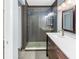 Updated bathroom featuring a glass-enclosed shower and single vanity at 2312 Heron Cir, Clearwater, FL 33762