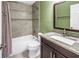 Bathroom featuring tile flooring, a shower-tub combo, and granite vanity at 2312 Heron Cir, Clearwater, FL 33762