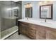 Modern bathroom showcasing a glass shower, dual vanity, and stylish fixtures at 2312 Heron Cir, Clearwater, FL 33762