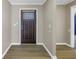 Welcoming entryway featuring hardwood floors, neutral paint, and a decorative front door with sidelight at 2312 Heron Cir, Clearwater, FL 33762