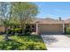 Charming single-story home with a well-manicured lawn, mature trees, and a two-car garage at 2312 Heron Cir, Clearwater, FL 33762
