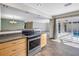Open kitchen featuring stainless steel oven and sliding doors that lead to the pool area at 2312 Heron Cir, Clearwater, FL 33762