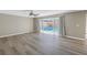 Spacious living area features wood floors and sliding glass doors to pool providing lots of natural light at 2312 Heron Cir, Clearwater, FL 33762