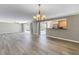 Open-concept living area, perfect for entertaining, with a view of the kitchen and sliding glass doors to the pool at 2312 Heron Cir, Clearwater, FL 33762