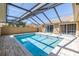 Inviting screened-in pool with brick pavers and sliding glass doors for easy indoor-outdoor living at 2312 Heron Cir, Clearwater, FL 33762