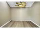Cozy, neutral room with wood floors and decorative ceiling fan, offering versatile space for various uses at 2312 Heron Cir, Clearwater, FL 33762