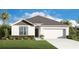 Charming one-story home with a two-car garage and manicured landscaping, offering great curb appeal at 245 Leafy Way Ave, Spring Hill, FL 34606