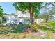 Back of home shows spacious yard with lush lawn, mature trees and privacy fence at 2581 Forest Run Ct, Clearwater, FL 33761