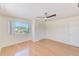 Inviting bedroom featuring wood flooring, a ceiling fan, and ample natural light at 2581 Forest Run Ct, Clearwater, FL 33761