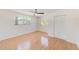 Bright bedroom with wood flooring, ceiling fan, and large windows at 2581 Forest Run Ct, Clearwater, FL 33761