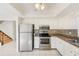 Well-lit kitchen featuring stainless steel appliances, ample cabinet space, and stylish backsplash at 2581 Forest Run Ct, Clearwater, FL 33761