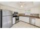 Modern kitchen featuring stainless steel appliances, white cabinets, granite counters, and neutral backsplash at 2581 Forest Run Ct, Clearwater, FL 33761