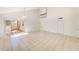 Spacious living room with tile floors, high ceilings, staircase, and sliding glass door leading to a patio at 2581 Forest Run Ct, Clearwater, FL 33761