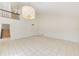 Bright living room with tile flooring, soaring ceilings, staircase, and a contemporary chandelier at 2581 Forest Run Ct, Clearwater, FL 33761