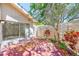 Brick patio leads to sliding door and is surrounded by privacy fence and landscaping at 2581 Forest Run Ct, Clearwater, FL 33761