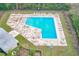 Overhead view of a rectangular pool surrounded by lounge chairs and lush greenery at 2581 Forest Run Ct, Clearwater, FL 33761