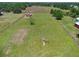 Aerial view of property showing home and surrounding fenced acreage with playground at 260 Moccasin Hollow Rd, Lithia, FL 33547