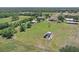 Aerial view showcasing home's expansive acreage, outbuildings, and idyllic rural setting at 260 Moccasin Hollow Rd, Lithia, FL 33547