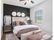 This stylish bedroom has a ceiling fan and is decorated with wall art and neutral colors at 260 Moccasin Hollow Rd, Lithia, FL 33547