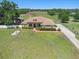 Charming ranch-style home featuring a well-manicured lawn, mature trees, and manicured landscaping at 260 Moccasin Hollow Rd, Lithia, FL 33547