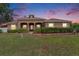 Charming ranch-style home boasts a well-manicured lawn, mature trees, and manicured landscaping at 260 Moccasin Hollow Rd, Lithia, FL 33547