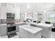 Bright kitchen featuring gray cabinets, stainless steel appliances, and a center island at 260 Moccasin Hollow Rd, Lithia, FL 33547