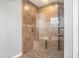 Tiled walk-in shower boasts a shower bench, shower niches, and decorative accents at 260 Moccasin Hollow Rd, Lithia, FL 33547