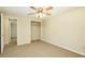 Neutral carpeted bedroom offers a ceiling fan and walk-in closet for storage at 3103 Taragrove Dr, Tampa, FL 33618