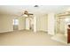 The bedroom is a serene retreat with plush carpeting, a ceiling fan, and access to an adjoining bathroom with a glass-enclosed shower at 3103 Taragrove Dr, Tampa, FL 33618