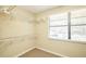 Walk-in closet provides storage with a window for natural light, rod iron shelving, and carpeted flooring for added comfort at 3103 Taragrove Dr, Tampa, FL 33618