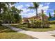 A charming house with a lush lawn, mature landscaping, and a view of a tree-lined street at 3103 Taragrove Dr, Tampa, FL 33618