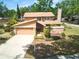 Charming two-story home with a well-manicured lawn and attached two-car garage at 3103 Taragrove Dr, Tampa, FL 33618