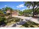 Charming home featuring an attached garage, a well-maintained lawn and lush landscaping at 3103 Taragrove Dr, Tampa, FL 33618