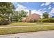 A beautiful home featuring a well-manicured lawn, mature tropical landscaping and a tall chimney at 3103 Taragrove Dr, Tampa, FL 33618
