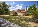 A charming house with a lush lawn, mature landscaping, and a tall chimney at 3103 Taragrove Dr, Tampa, FL 33618