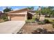 A well-maintained home with attached two-car garage, mature landscaping, and manicured lawn at 3103 Taragrove Dr, Tampa, FL 33618