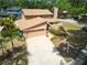 Beautiful home with a two-car garage, well-manicured lawn and front-yard tropical landscaping at 3103 Taragrove Dr, Tampa, FL 33618