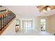 Open living area boasting a wet bar, staircase, bright windows, and access to the dining area at 3103 Taragrove Dr, Tampa, FL 33618