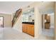 Open-concept living area featuring a wet bar, staircase, and views of the surrounding living space at 3103 Taragrove Dr, Tampa, FL 33618