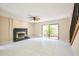Bright living room featuring a decorative fireplace, tile floors, and sliding glass doors leading to the patio at 3103 Taragrove Dr, Tampa, FL 33618