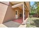 Covered patio area of a tan house showing white supports, door, and window at 3103 Taragrove Dr, Tampa, FL 33618