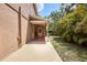 Tan house with a covered patio and view of green grass and landscaping at 3103 Taragrove Dr, Tampa, FL 33618