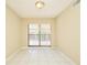 Room with neutral walls, tiled floor, and sliding glass doors to the exterior at 3103 Taragrove Dr, Tampa, FL 33618