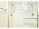 Glass enclosed shower with double shower heads, tile surround, recessed soap holders and a grab bar for safety and convenience at 3103 Taragrove Dr, Tampa, FL 33618