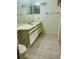 Bathroom featuring a white single sink vanity with brown accents, a toilet, and tile flooring at 3629 Indigo Pond Dr # 3629, Palm Harbor, FL 34685
