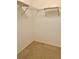 Walk-in closet featuring neutral carpeting and a built-in wire shelving system for optimal storage at 3629 Indigo Pond Dr # 3629, Palm Harbor, FL 34685