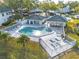 Aerial view of the community pool with sun loungers surrounded by lush landscaping at 3629 Indigo Pond Dr # 3629, Palm Harbor, FL 34685